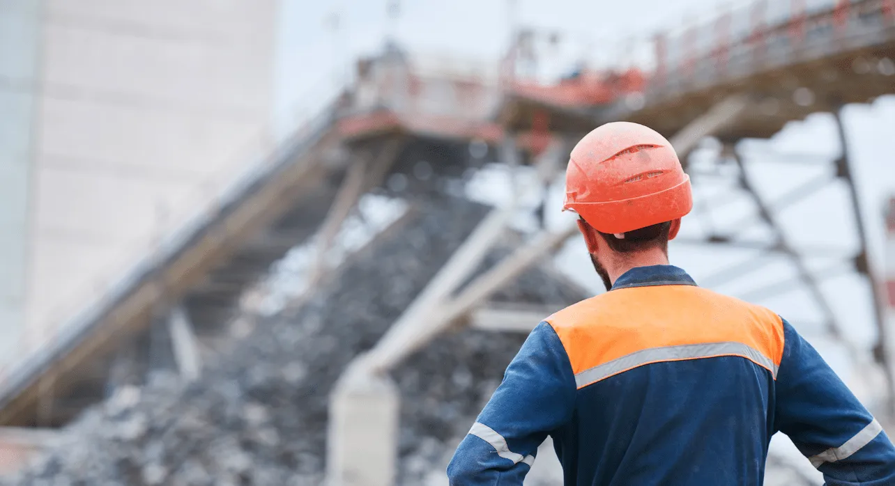 Engineer in hard hat inspecting a conveyor installation on site