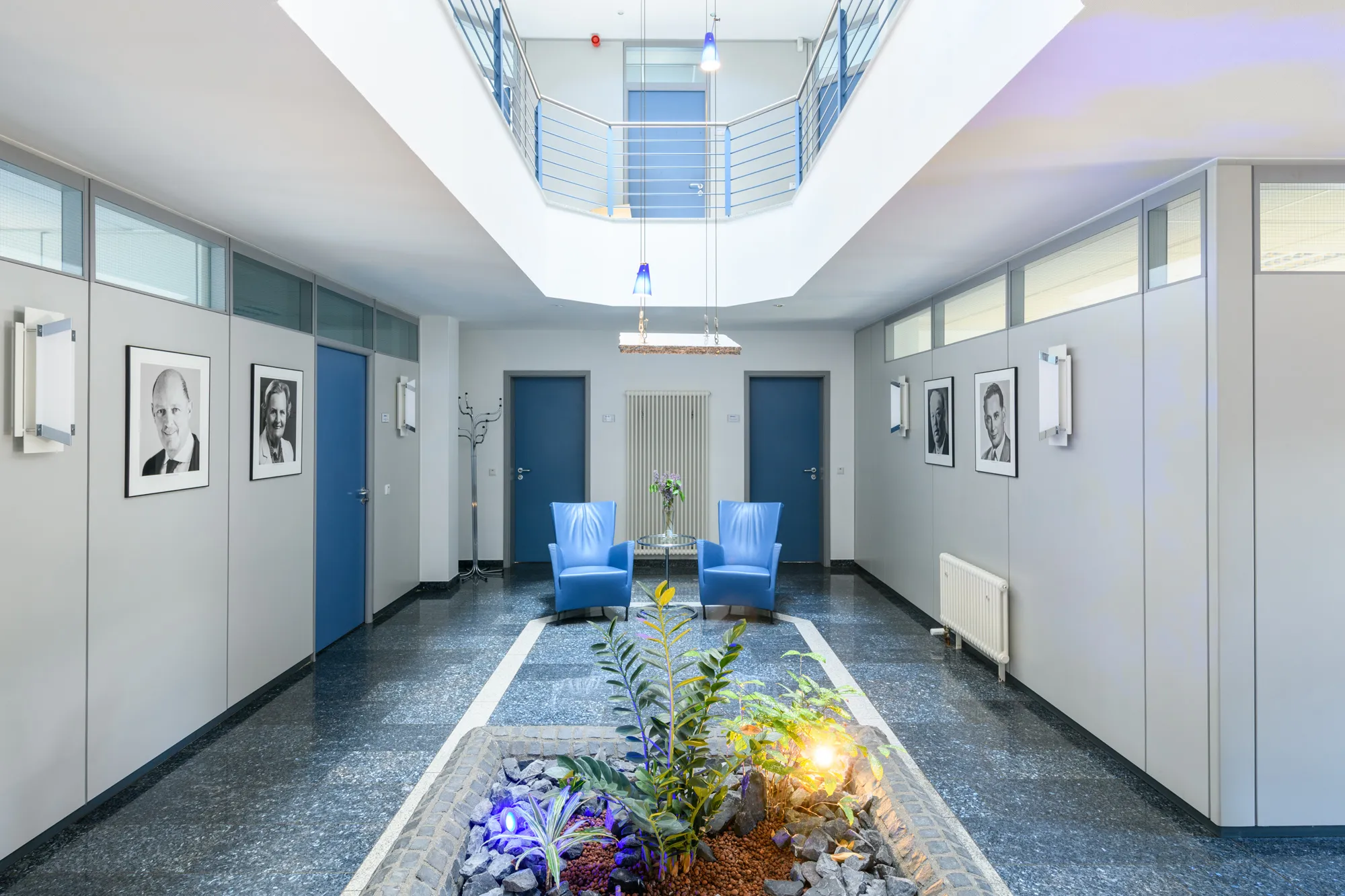 Bright hallway with framed photographs in the thenex office building in Bocholt