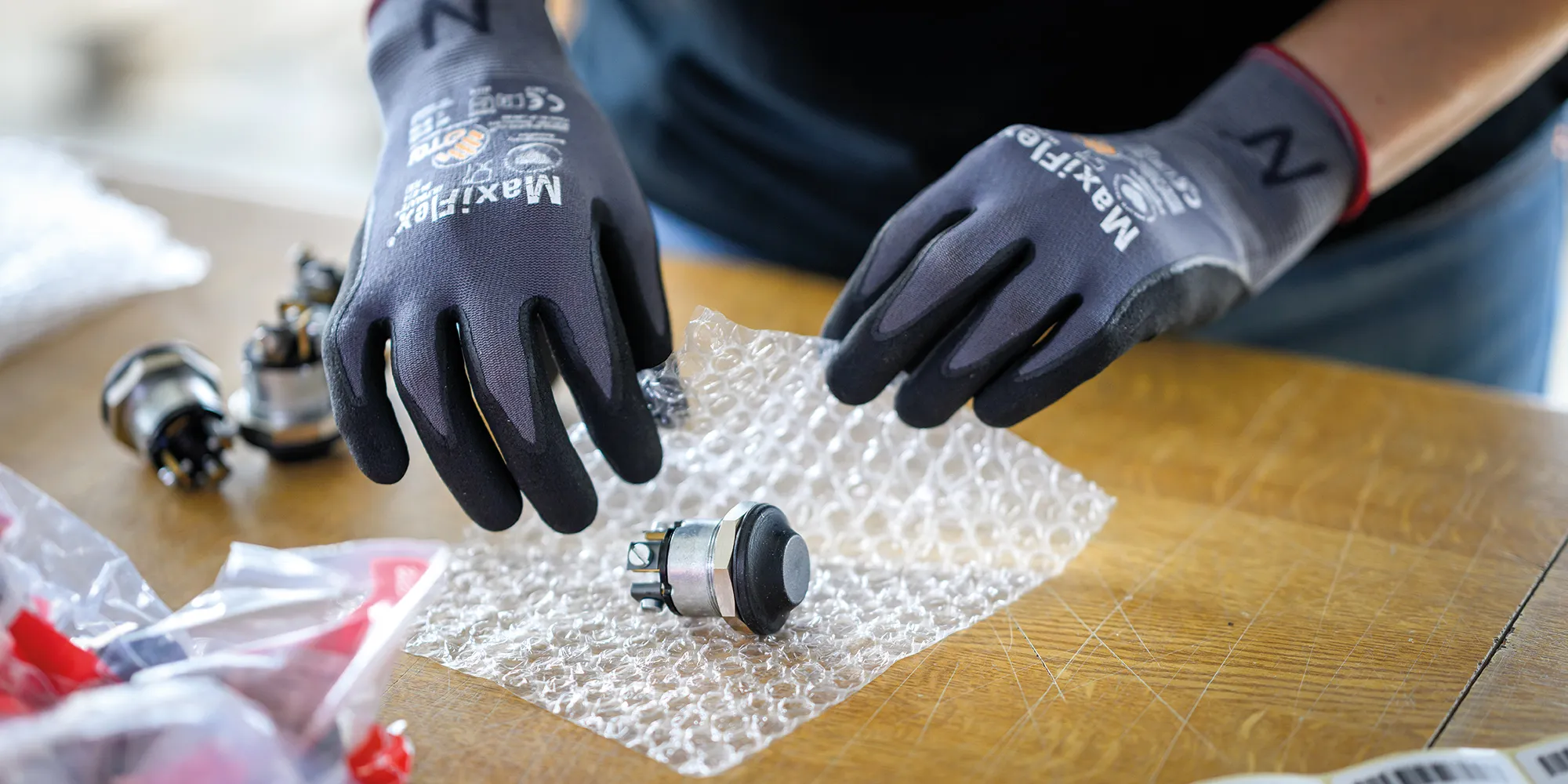 thenex employee in protective gloves checking electronic components for dispatch